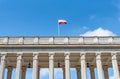 Flag of Poland on top of the building on blue sky background