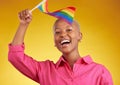 Flag, pride and portrait of black woman with support of the lgbtq community isolated in a studio yellow background