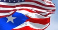 Flag of Puerto Rico waving with the United States flag on a clear day Royalty Free Stock Photo