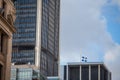 Flag of Quebec waiving in Old Montreal, Quebec, Canada, surrounded by modern office buildings and old skyscrapers.