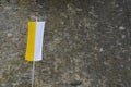 Flag of Roman Catholic Church in yellow and white hanging vertically on a pole.