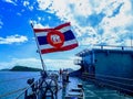 The flag of the Royal Thai Navy waving on a warship