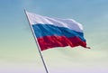 Flag of Russia against the yellow-blue sky at dawn. Escalation of the conflict. Royalty Free Stock Photo
