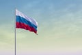 Flag of Russia against the yellow-blue sky at dawn. Escalation of the conflict. Royalty Free Stock Photo