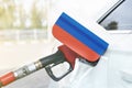 Flag of Russia on the car`s fuel filler flap with gas pump nozzle in the tank Royalty Free Stock Photo