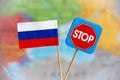 Flag of Russia and stop sign over the world map. Stop war and aggression concept Royalty Free Stock Photo