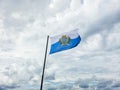 Flag of San Marino with clouds in background Royalty Free Stock Photo