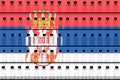 Flag of Serbia and multiple vaccine vials. Vaccination concept. 3D rendering