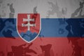 flag of slovakia on the khaki texture . military concept