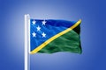 Flag of Solomon Islands flying against a blue sky