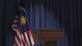 National flag of Malaysia and speaker podium tribune. Political event or statement related conceptual 3D rendering