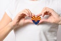Flag of the State of Arizona in the shape of a heart in the hands of a girl. Love Arizona. Royalty Free Stock Photo