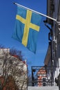 Flag of Sweden waving above the balcony of a building