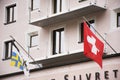Flag of Swiss on front of building shop in Samnaun village Royalty Free Stock Photo