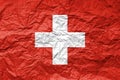 Flag of Switzerland on crumpled paper. Textured background Royalty Free Stock Photo