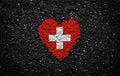 Flag of Switzerland, Swiss flag, heart on the black background, stones, gravel and shingle, textured wall Royalty Free Stock Photo