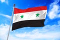 Flag of Syria Syrian Arab Republic developing against a blue sky