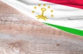 Flag Tajikistan and space for text on a wooden background