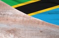 Flag Tanzania and space for text on a wooden background
