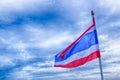 The flag of Thailand with red, blue and white stripes is fixed on the flagpole, develops against the background of a dark stormy Royalty Free Stock Photo