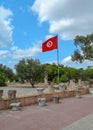 The flag of Tunisia against the blue sky on the ruins of Carthage Royalty Free Stock Photo