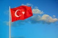 Flag of Turkey waving in the wind against evening blue sky. Royalty Free Stock Photo