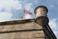 Flag and turret on Naryshkin bastion of Peter and Paul Fortress on a background cloudy sky in St-Petersburg