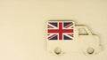 Flag of the UK on the recycled cardboad truck icon, national sustainable logistics concept