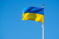 Flag of Ukraine against the background of a bright blue sky