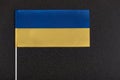 Flag of Ukraine on black background. National symbols of Ukraine. Yellow and blue flag close up