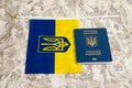 Ukraine, Chernihiv, July 5, 2023: Flag of Ukraine with coat of arms and passport of citizen of Ukraine on light gray