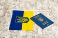 Ukraine, Chernihiv, July 5, 2023: Flag of Ukraine with coat of arms and passport of citizen of Ukraine on light gray