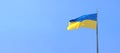 The flag of Ukraine develops against the blue sky Royalty Free Stock Photo