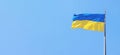 The flag of Ukraine develops against the blue sky Royalty Free Stock Photo