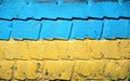 Flag of Ukraine on old grunge wall in background. Grunge wall paint with Ukraine national flagposter, banner of the national flag.