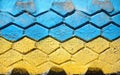 Flag of Ukraine on old grunge wall in background. Grunge wall paint with Ukraine national flagposter, banner of the national flag.