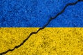 Flag of Ukraine painted on cracked wall background/Ukrainian civil war concept