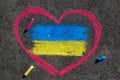 Flag of Ukraine and pink heart. Chalk drawing on sidewalk. Royalty Free Stock Photo