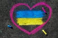 Flag of Ukraine and pink heart. Chalk drawing on sidewalk. Royalty Free Stock Photo