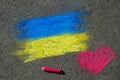 Flag of Ukraine and pink heart. Chalk drawing on sidewalk. Royalty Free Stock Photo