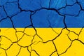 Flag of Ukraine on the texture of cracked earth. Russian-Ukrainian military conflict Royalty Free Stock Photo