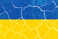 Flag of Ukraine on the texture of cracked earth. Russian-Ukrainian military conflict Royalty Free Stock Photo