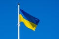 Flag of Ukraine waving against a blue sky