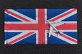 Flag of United Kingdom and toy airplane. Air travel in UK. Resuming flights after quarantine Royalty Free Stock Photo