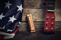 Flag of the United States of America, harmonica and guitar neck on an old wooden background Royalty Free Stock Photo