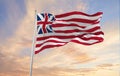 flag of United States 1776-1777 at cloudy sky background on sunset. Patriotic concept about state. Flag day.