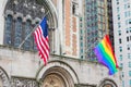 Flag of the United States, Rainbow Pride Flag flying waving on the facade of St. Bartholomew`s Church Royalty Free Stock Photo