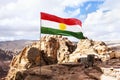 Flag of unrecognized Republic of Kurdistan in the mountains against the sky and nature of the middle East