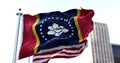 The flag of the US state of Mississippi waving in the wind with the American flag blurred in the background Royalty Free Stock Photo