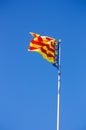 Flag of the Valencian Community with a blue background of the summer sky Royalty Free Stock Photo